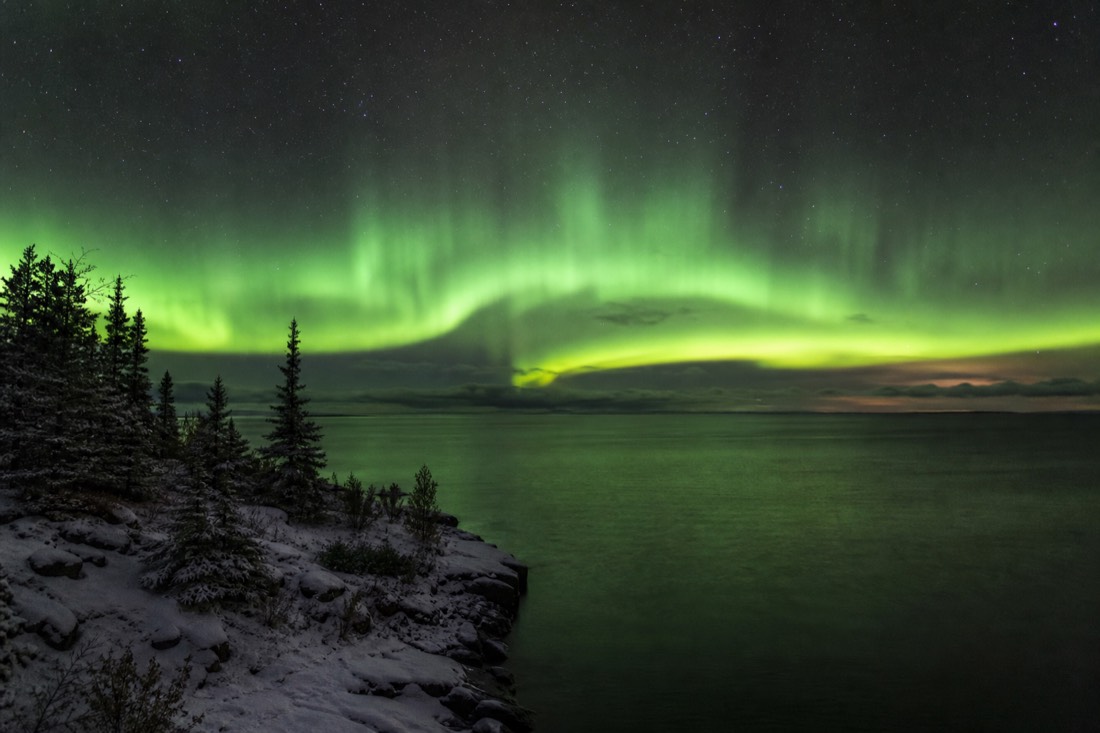 Late August aurora shimmering above open dark water before freeze-up on Great Slave Lake