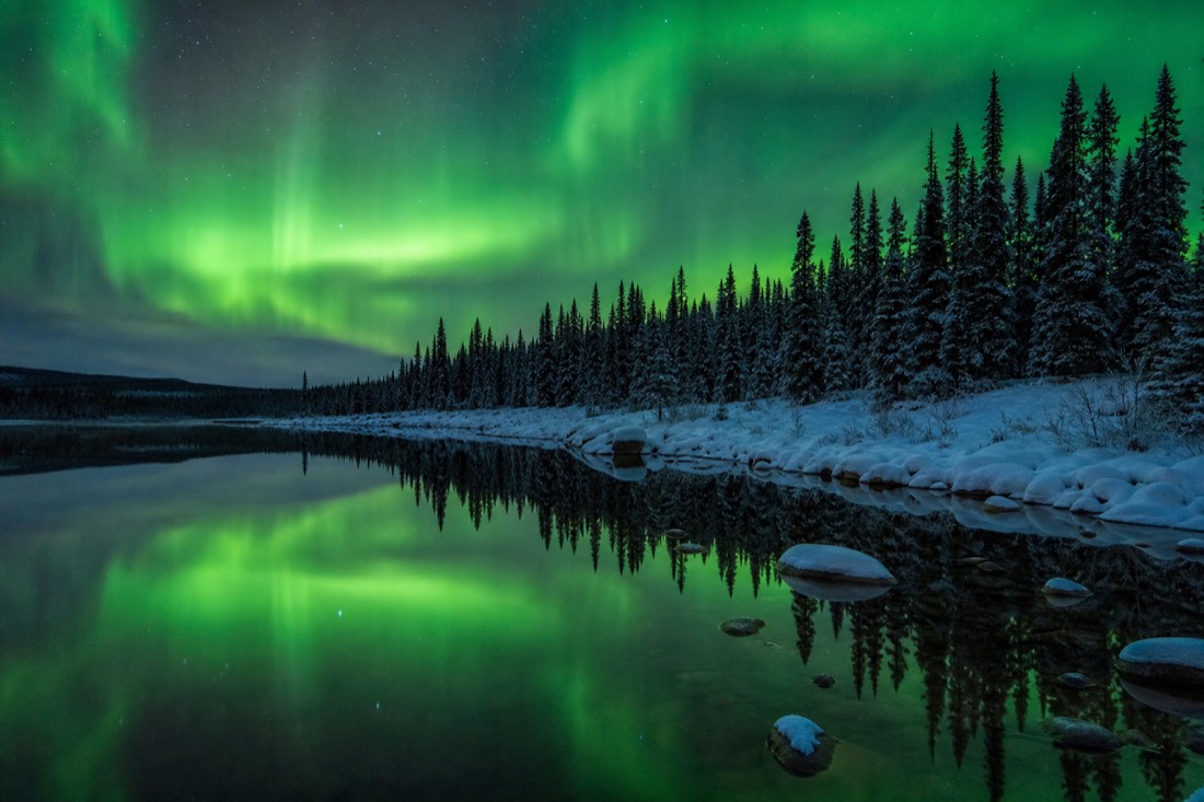 September aurora reflected in the still open water of a subarctic lake before freeze-up