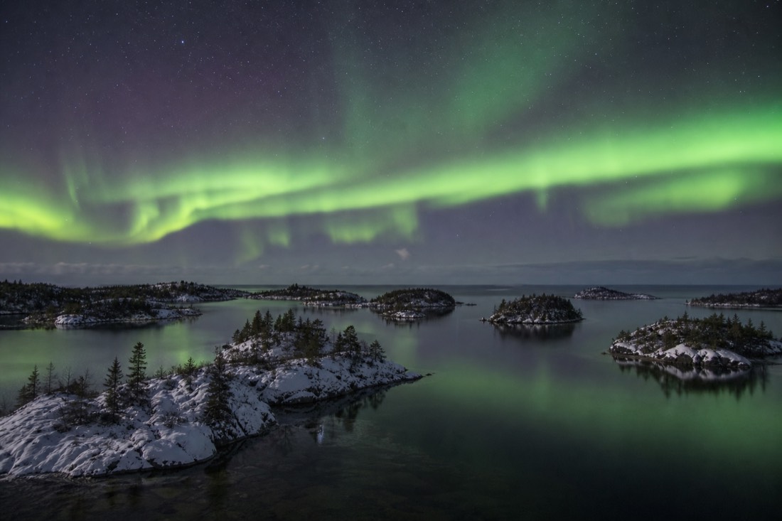 Cluster of rocky spruce-topped islands scattered across the clear water of the lake's East Arm