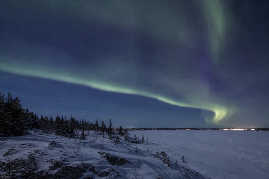 Pale blue midnight sky over Great Slave Lake ice in mid-April Yellowknife with no stars visible